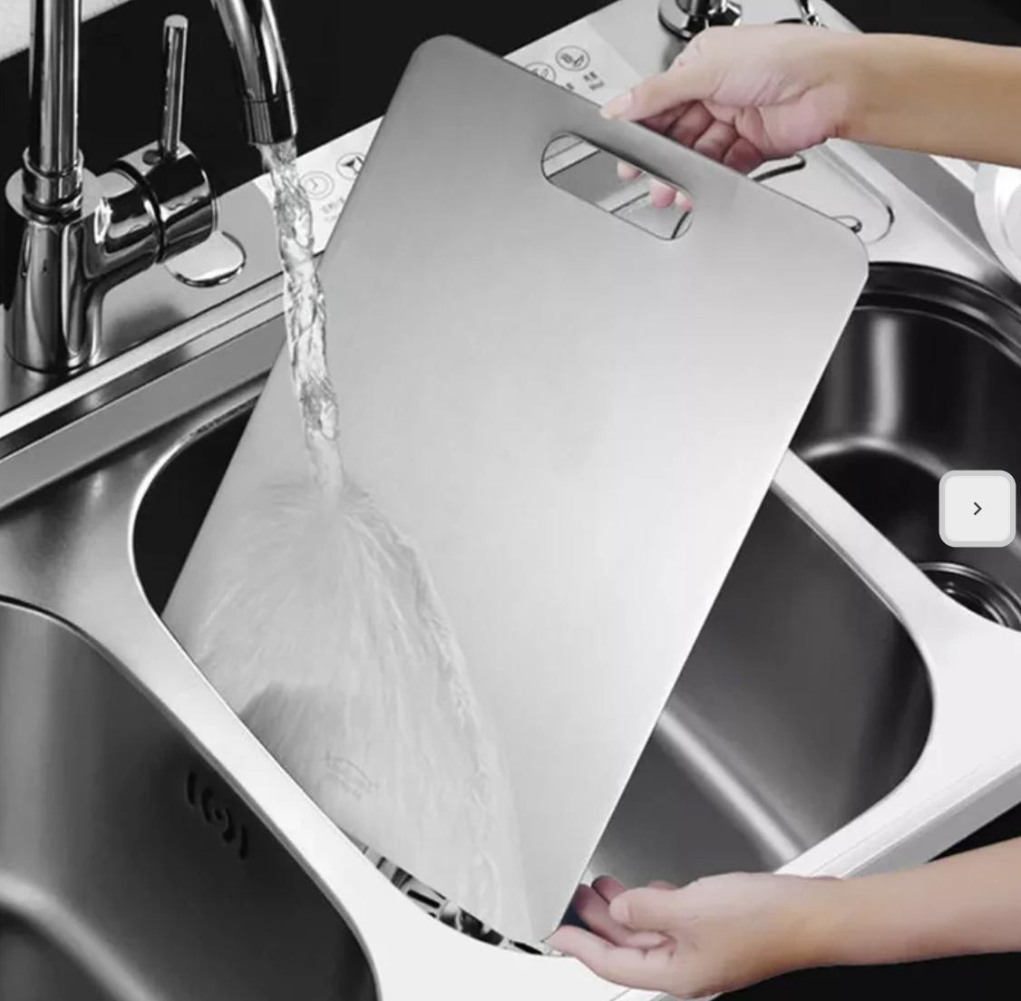 Chef chopping vegetables on a titanium cutting board, showcasing its scratch-resistant surface and durability