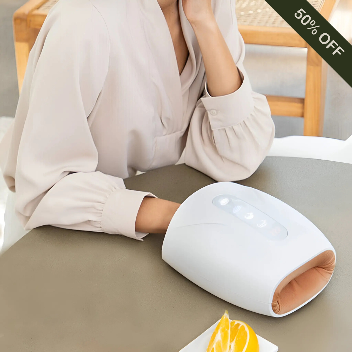Person using cordless hand massager with heat and air compression therapy for soothing wrist, palm, and finger pain relief at home