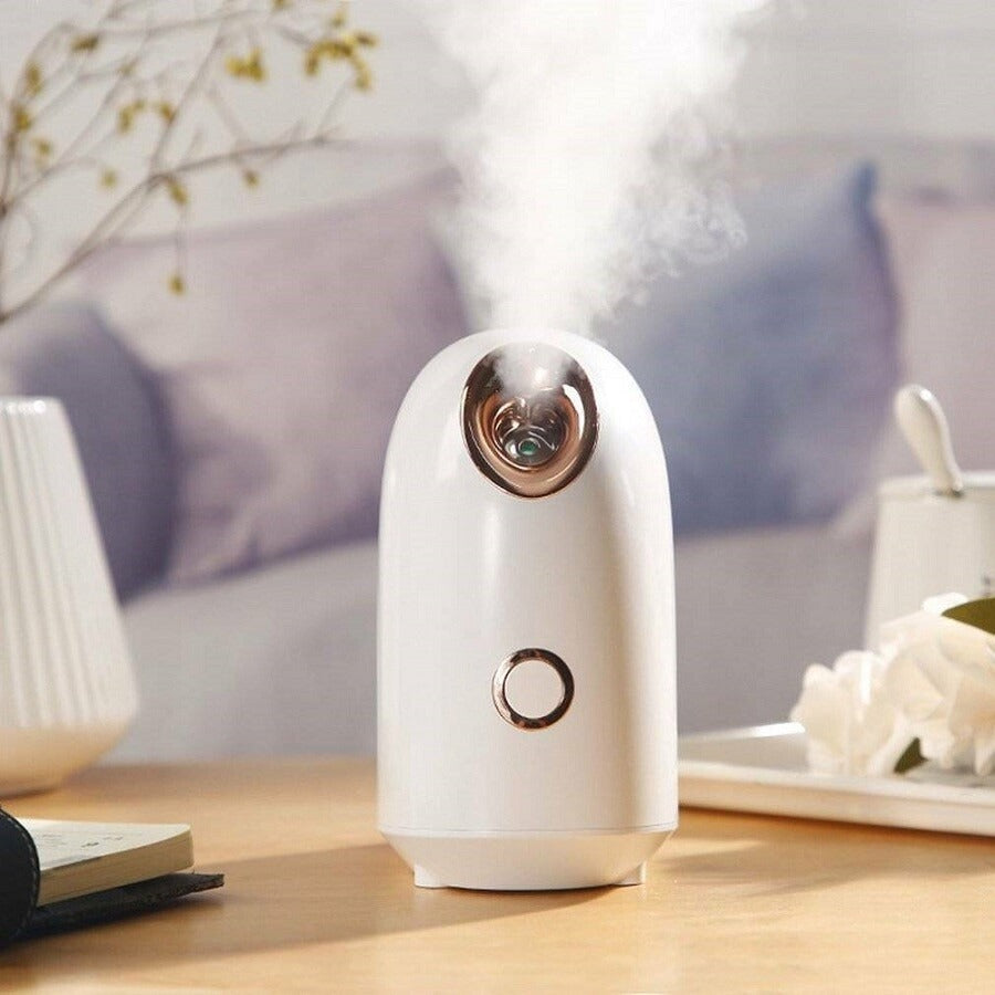 Facial steamer on bathroom countertop releasing warm mist for deep pore cleansing, hydration, and spa-like skincare.