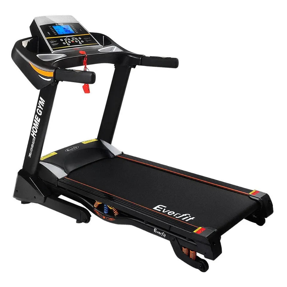 Incline treadmill positioned in a home gym, featuring high-incline capability and smooth running surface.