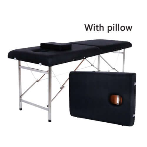 Black massage table with included pillow, sturdy metal legs, and a foldable design, accompanied by a matching carrying case for easy transport and storage.