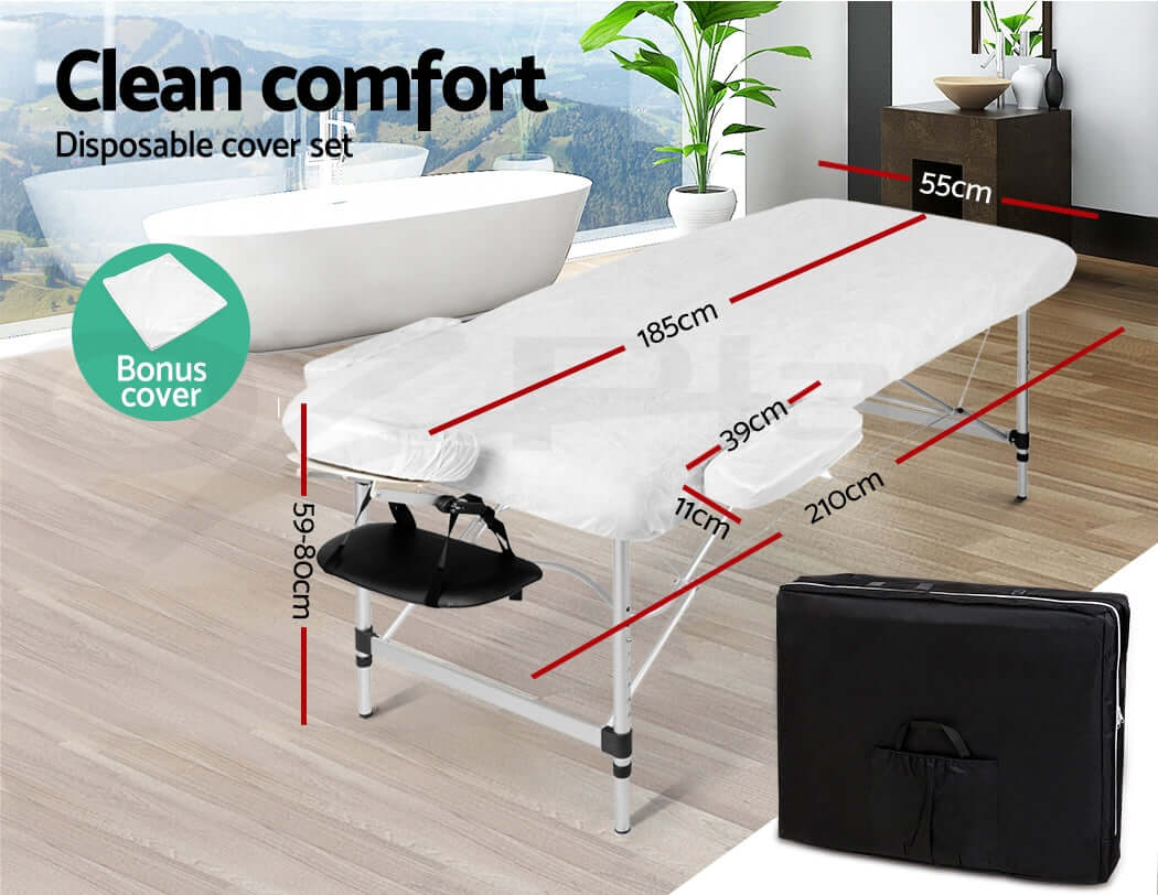 White massage table with adjustable headrest, foldable metal legs, and padded cushioning for optimal comfort, accompanied by a black carrying case for easy portability.