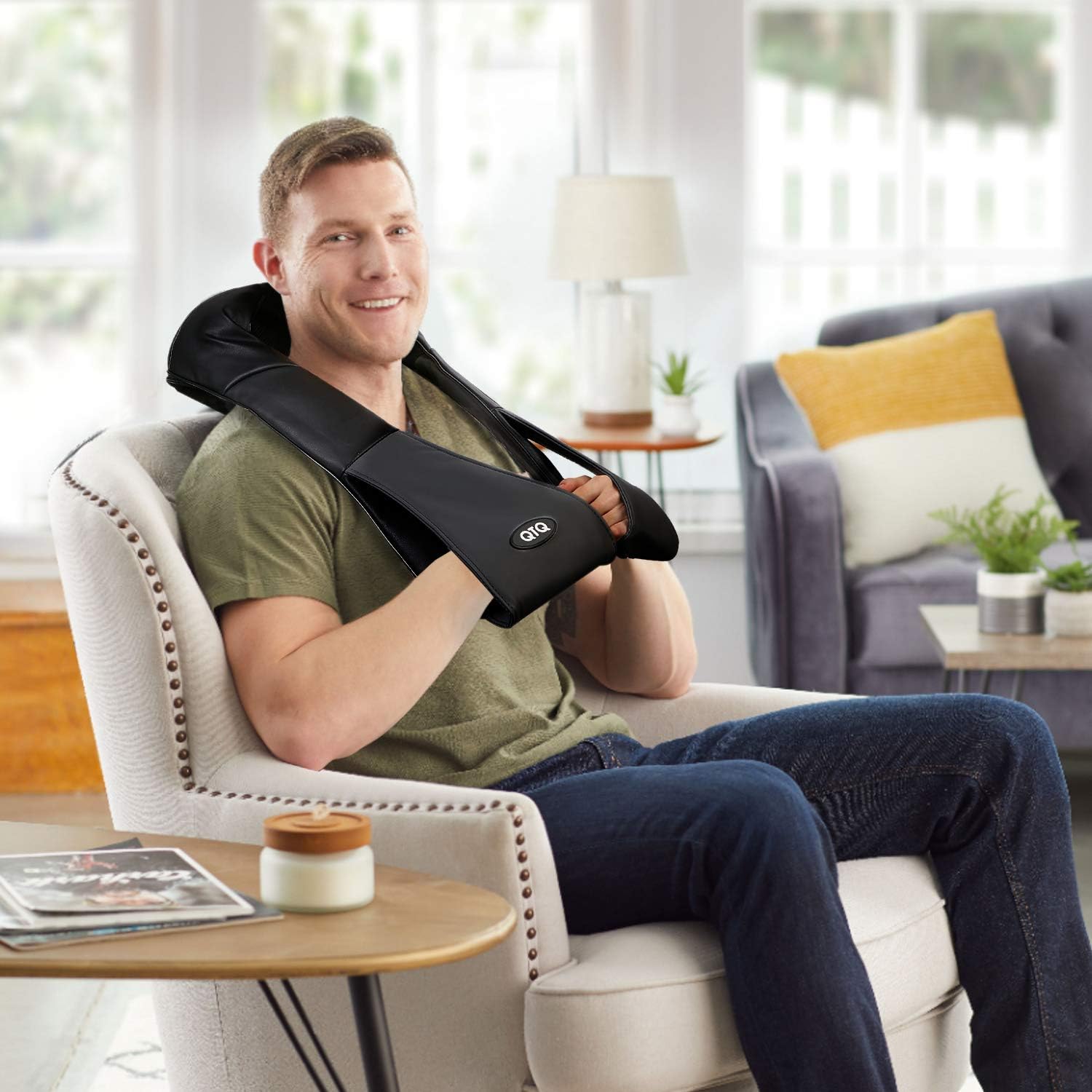 Man relaxing at home using heated neck and shoulder massager for pain relief and stress reduction