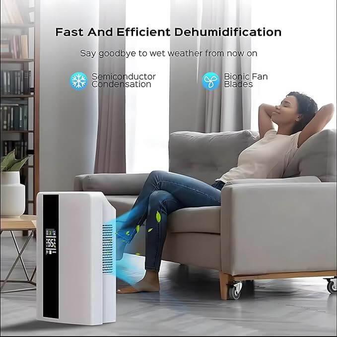 Person relaxing on a couch with a modern dehumidifier operating nearby, creating a comfortable and moisture-free indoor environment.