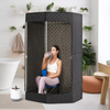 Portable sauna tent in a home setting with a person sitting inside enjoying infrared heat therapy for relaxation and detox benefits.