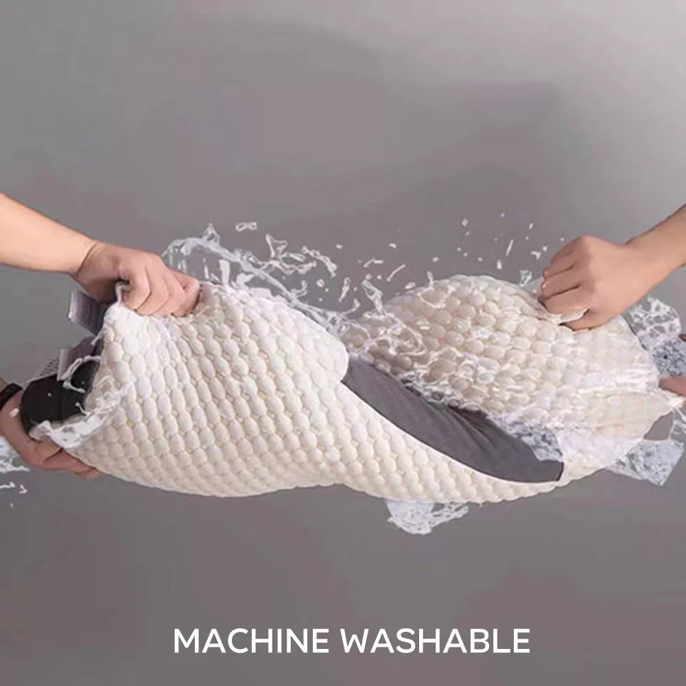 Ergonomic pillow with machine washable cover being stretched to show durability and easy maintenance