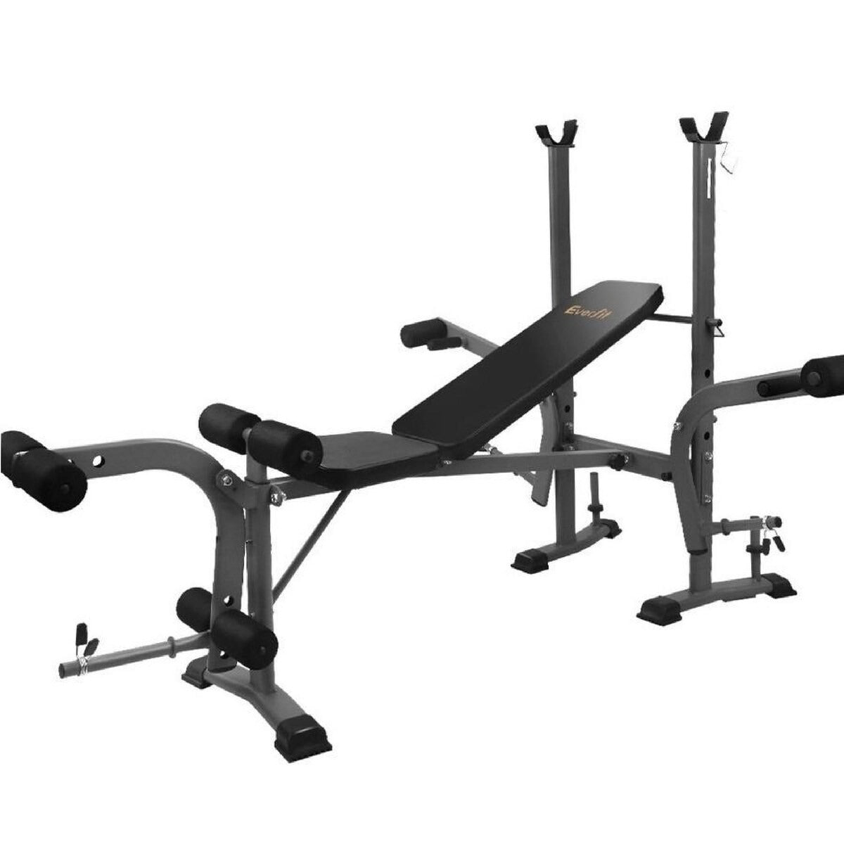 Weight bench with preacher curl and leg extension attachments for arm and leg workouts