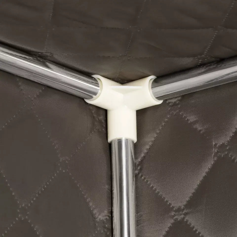 Close-up of the interior frame connection of a sauna tent, showing the sturdy plastic joint and metal support poles against the quilted insulated fabric. Highlights the tent's durable and easy-to-assemble construction