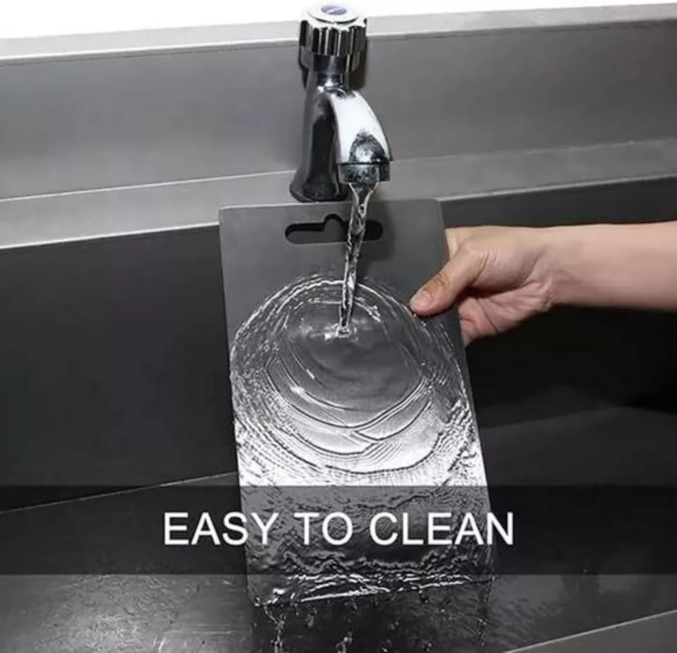 Hand rinsing a Titanium Cutting Board under running water in a modern kitchen sink. Text overlay reads 'Easy to Clean,' highlighting the board’s non-stick and hygienic surface.
